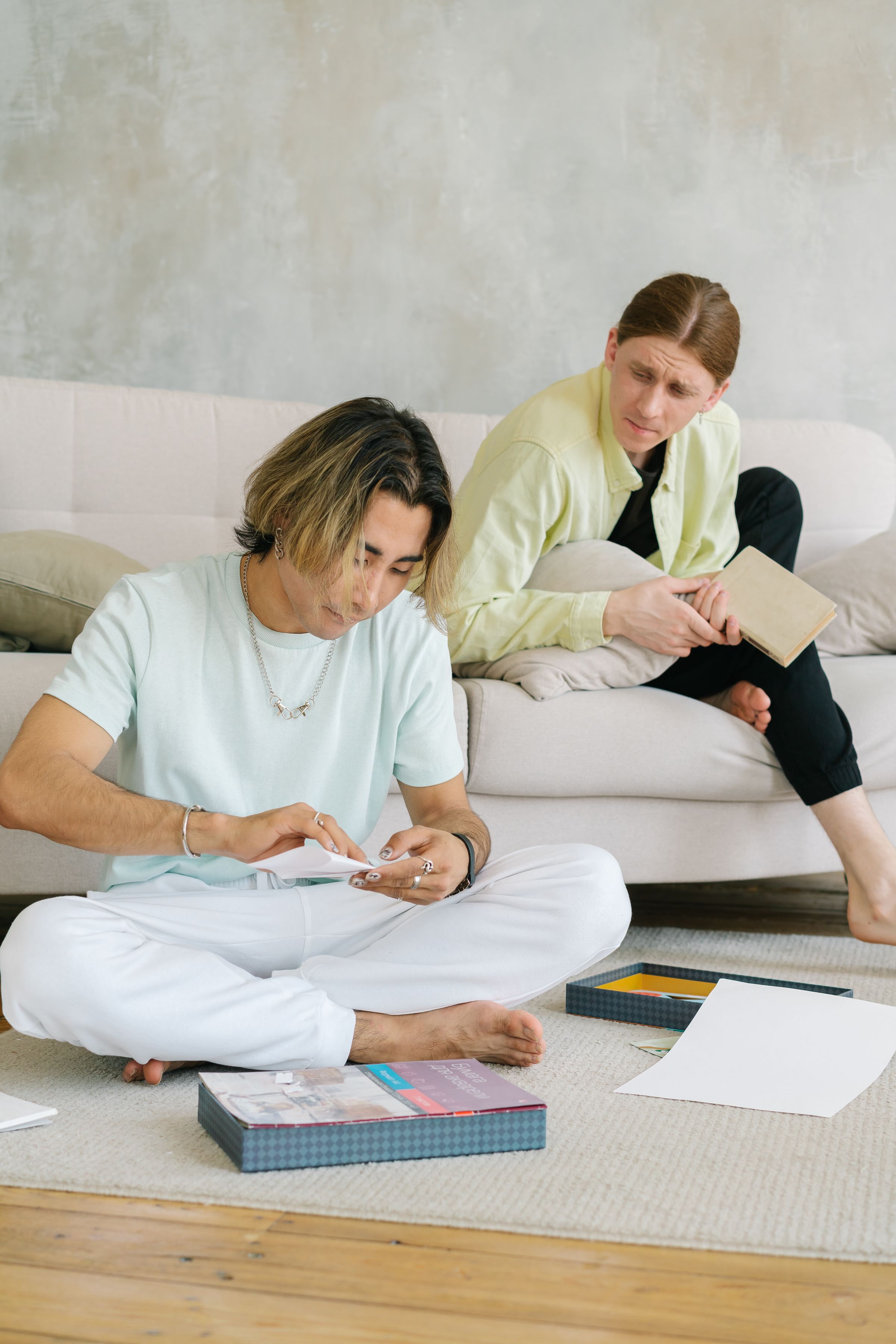 Two partners relaxing together in a bright, comfortable living room.